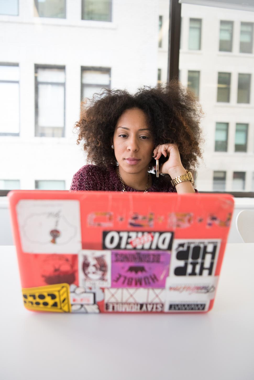 Free Image of Stylish young woman with laptop and smartphone - looking at scre 
