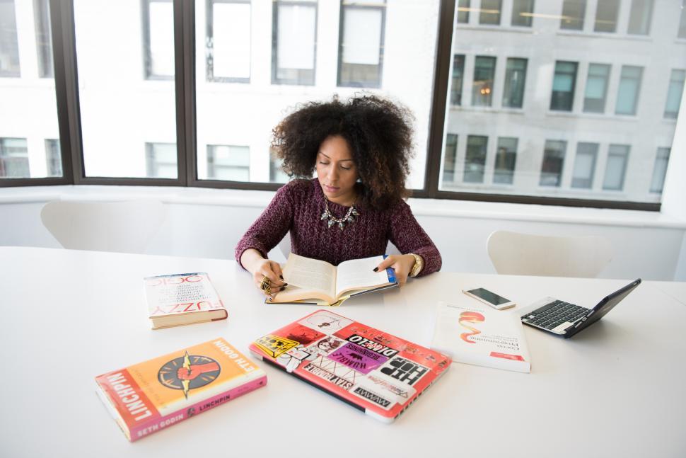 Free Image of Female developer with books near glass window 
