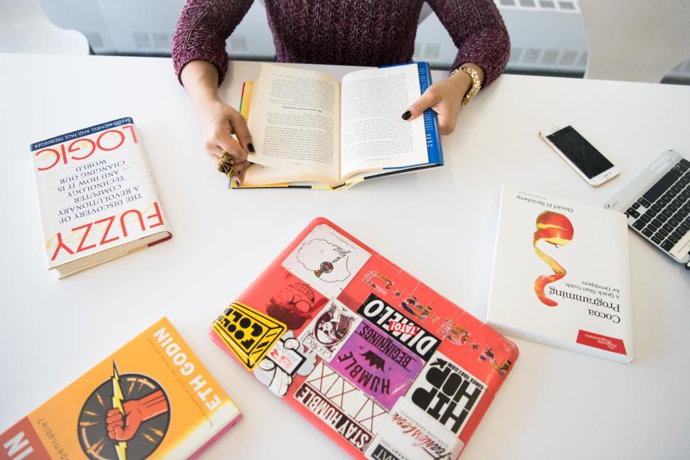 Free Image of Female developer with books and laptop 