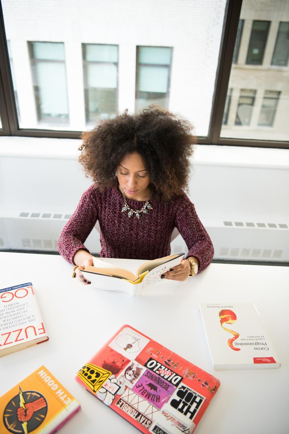 Free Image of Female developer with books - looking down 