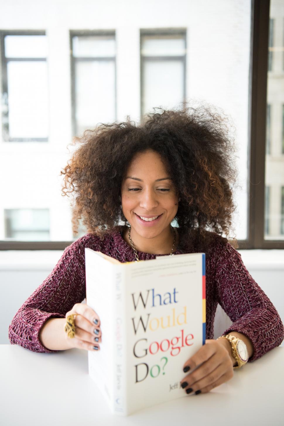 Free Image of Happy Female developer with book 