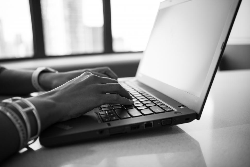 Free Image of Hands typing on laptop keyboard - b&w 