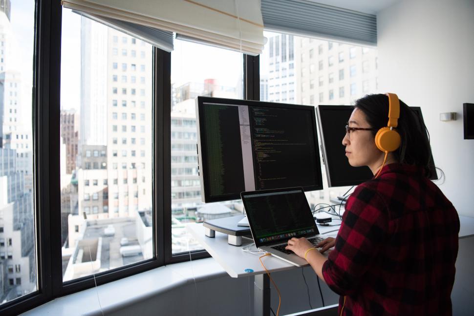 Free Image of Female developer in glasses with desktop computers 