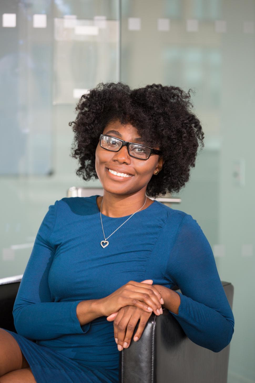 Free Image of Female professional smiling for camera in office 