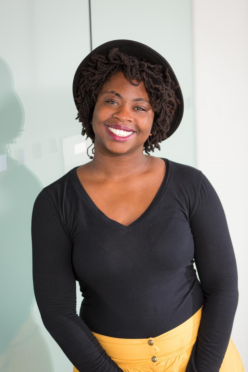 Free Image of Smiling female professional smiling for camera in office 