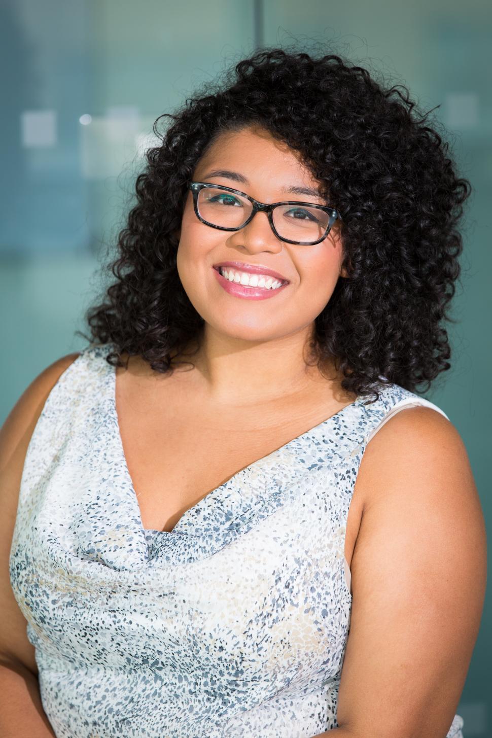 Free Image of Stylish female professional smiling for camera in office 