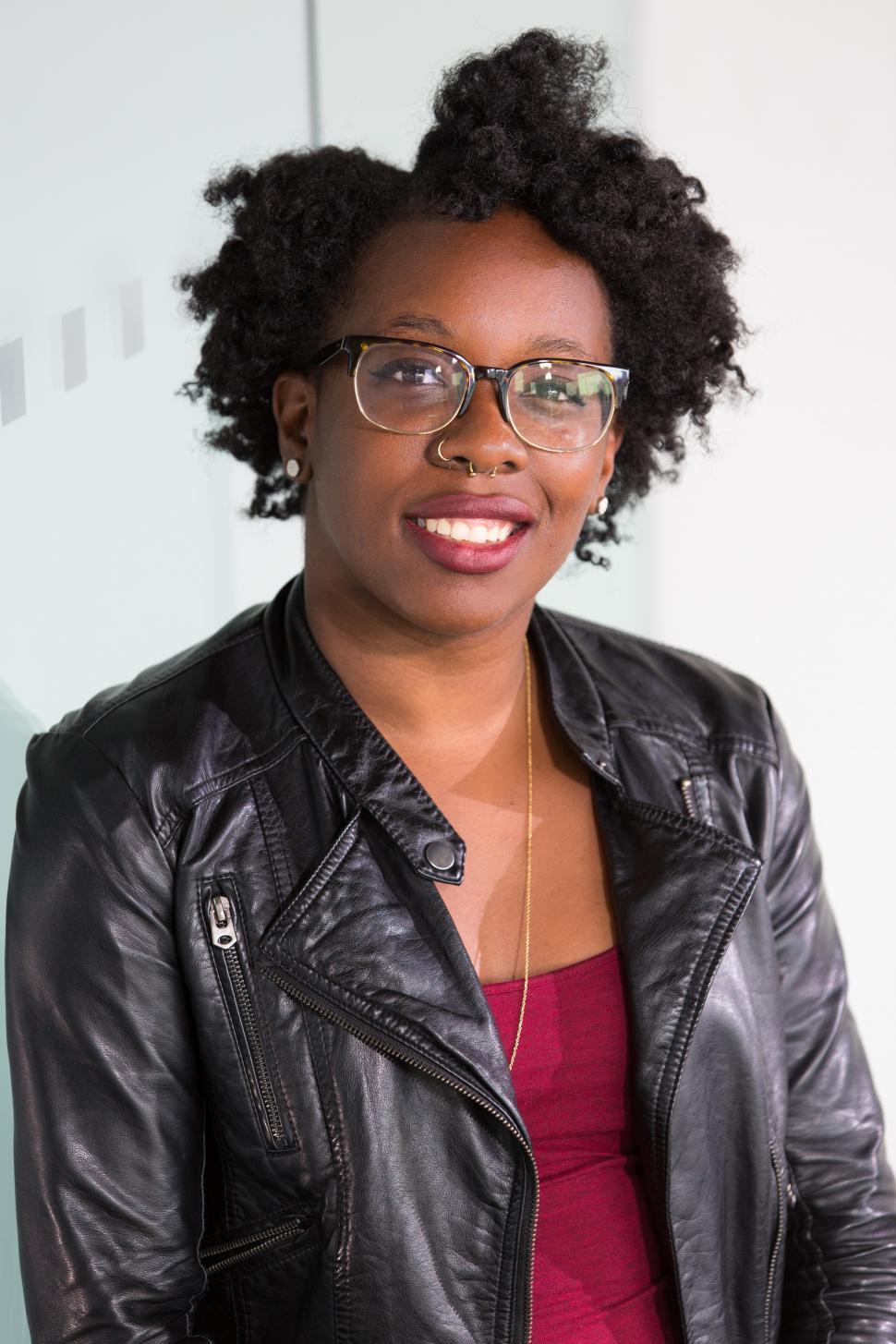 Free Image of Stylish female professional smiling for camera in office 