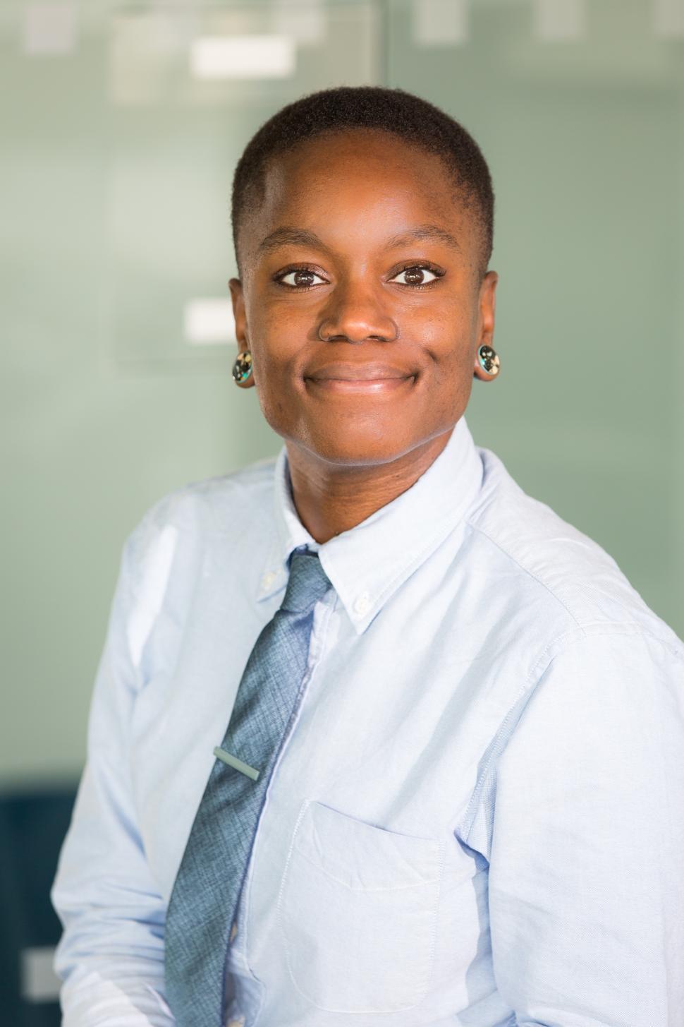 Free Image of Happy female professional poses for camera in office 