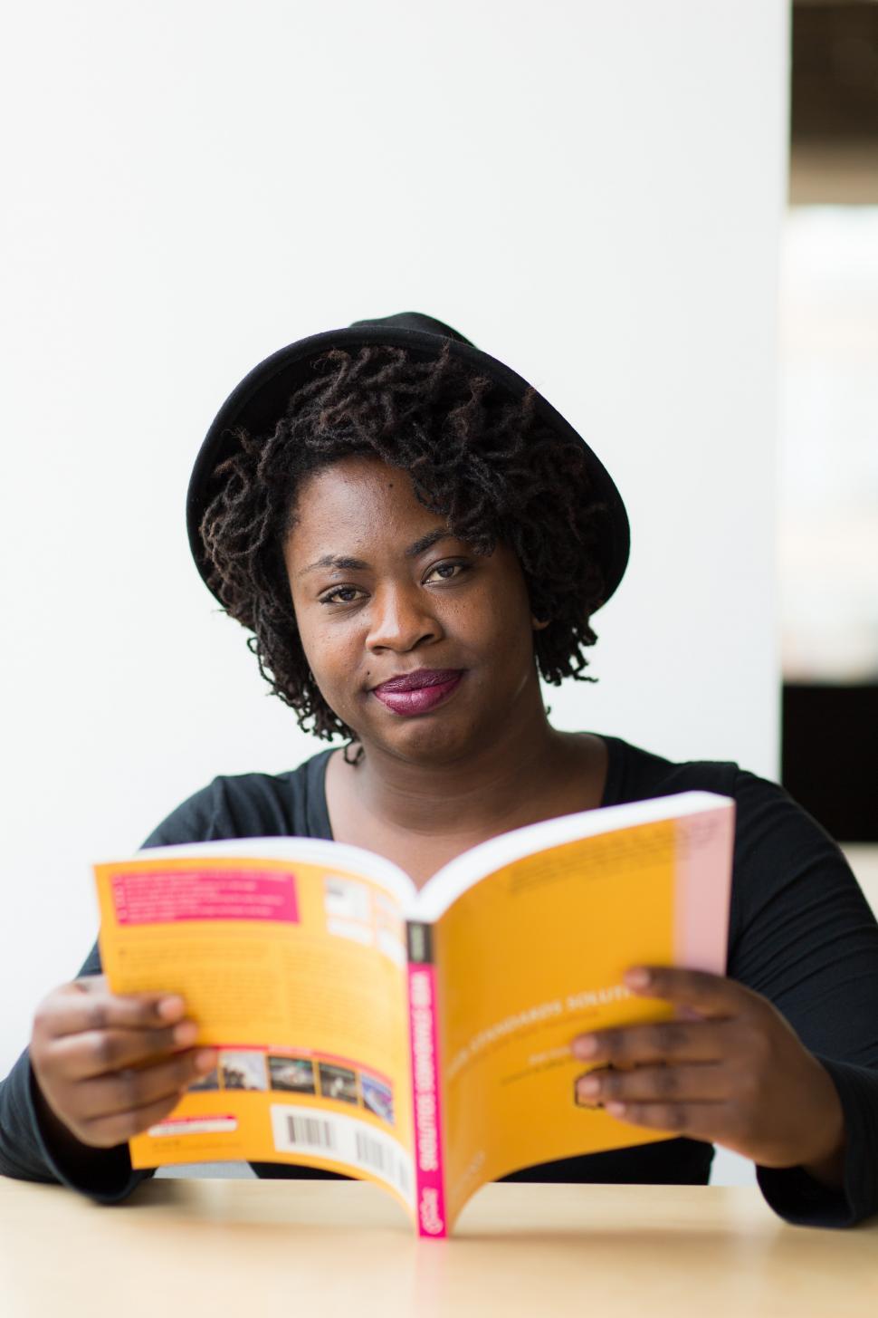Free Image of Happy Female software developer with book 