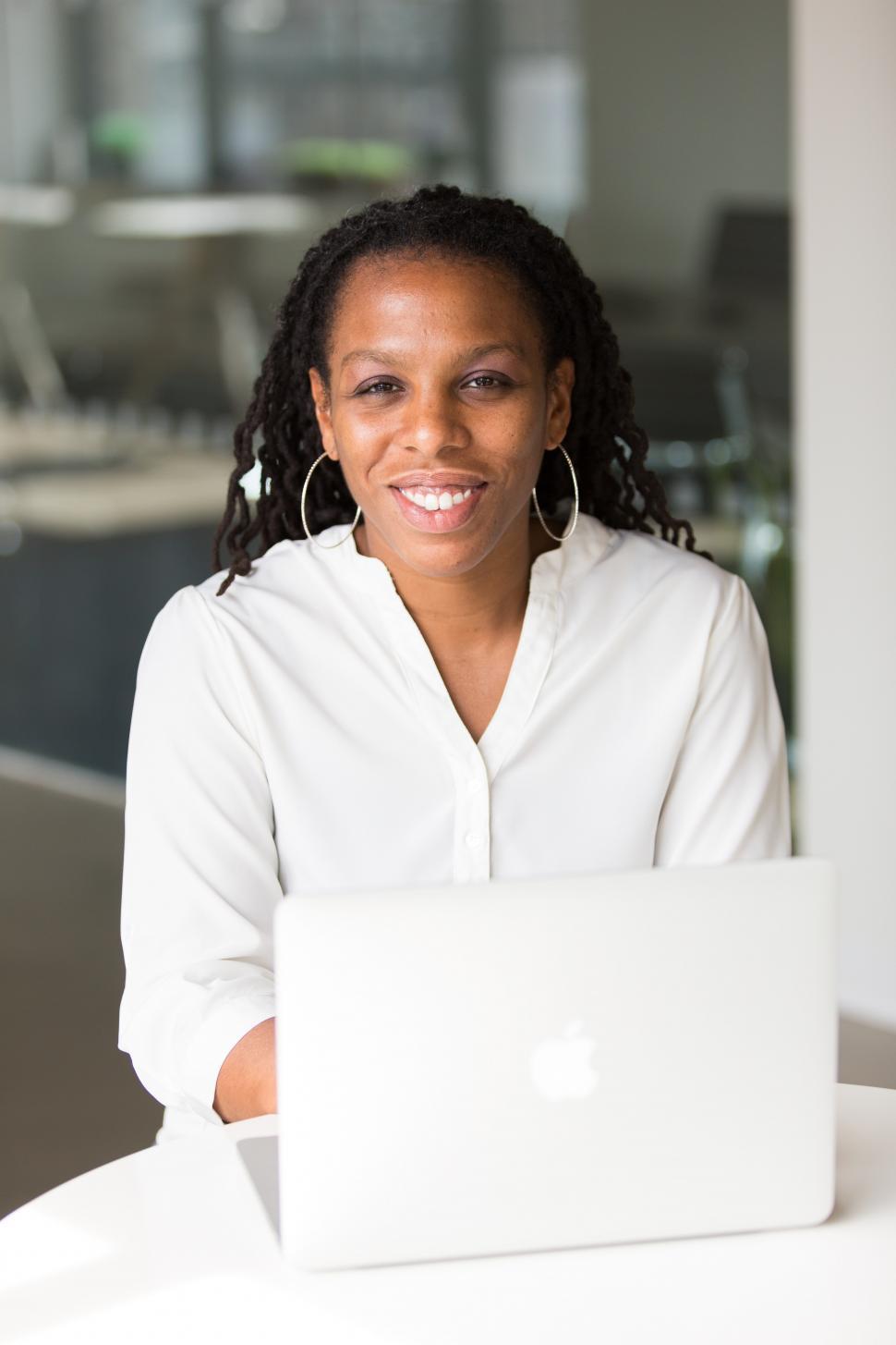 Free Image of Happy Businesswoman with laptop - looking at camera 