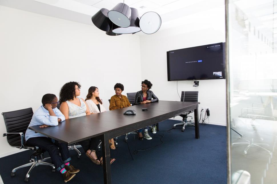 Free Image of Business people sitting in front of television for video call 