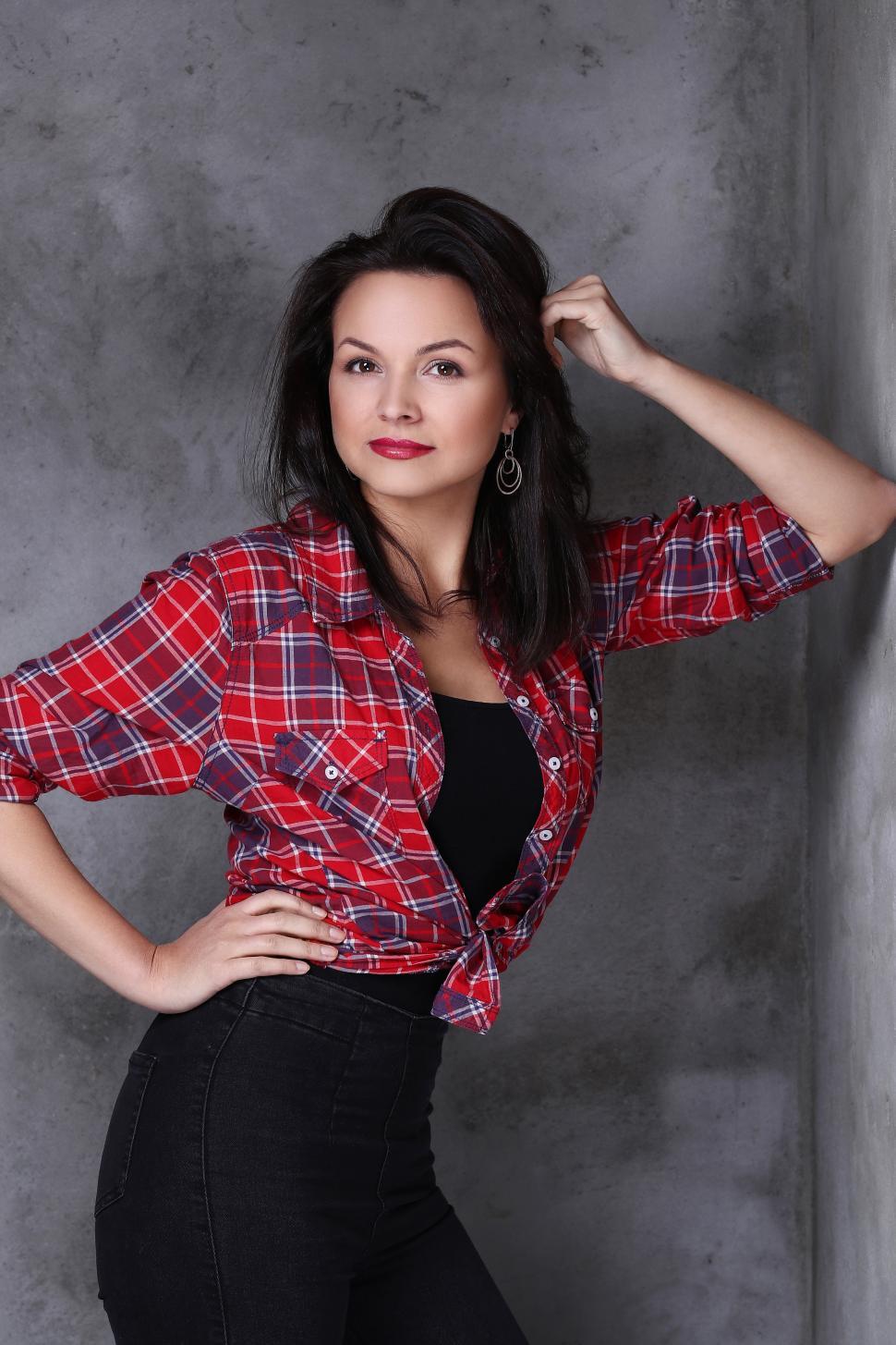 Free Image of Lovely woman posing against concrete 