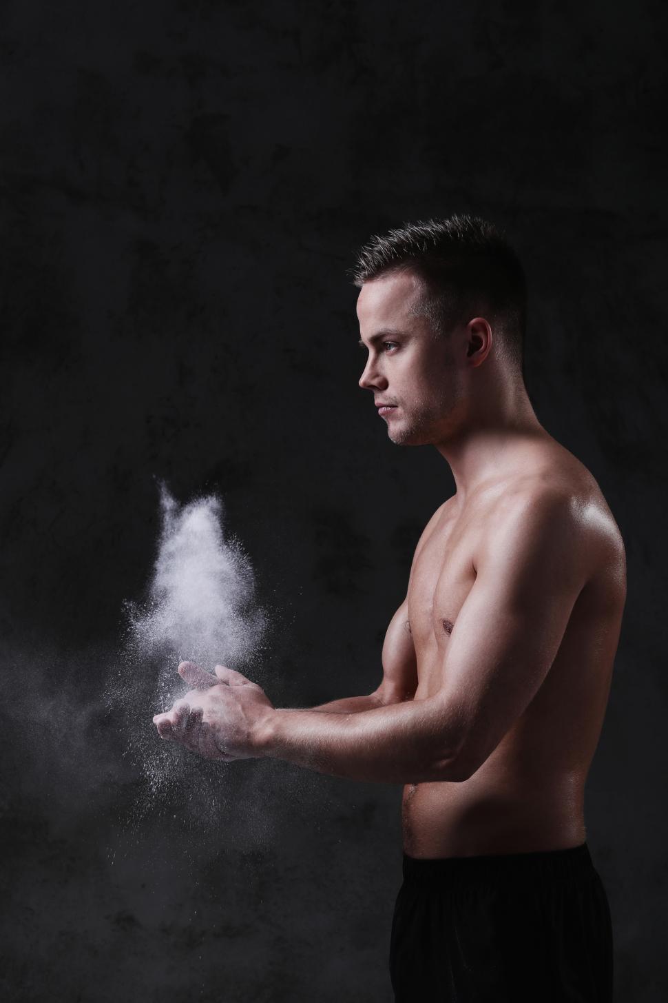 Free Image of Man with chalked up hands 