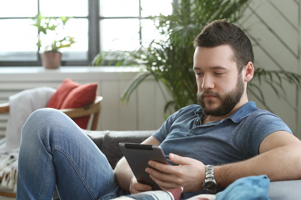 Free Image of On the couch with a tablet device 