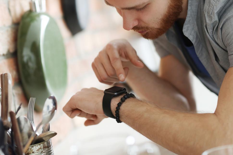Free Image of Man interacting with smartwatch 