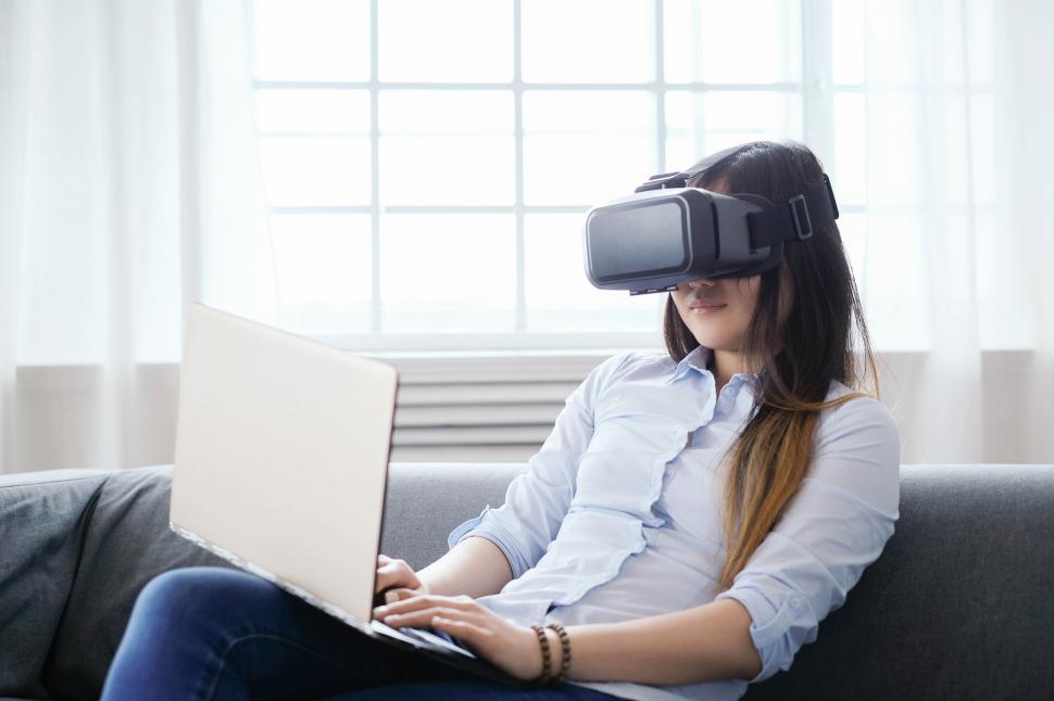Free Image of Woman at home using VR goggles 