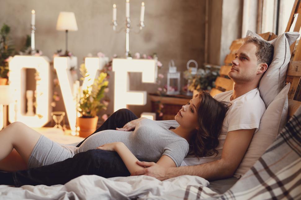 Free Image of Pregnant couple relaxing together 