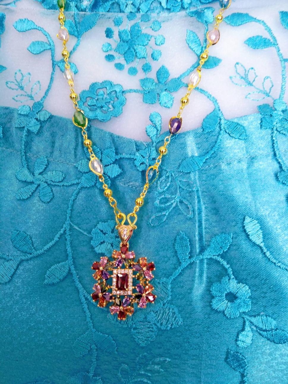 Free Image of Jeweled necklace on a blue dress  
