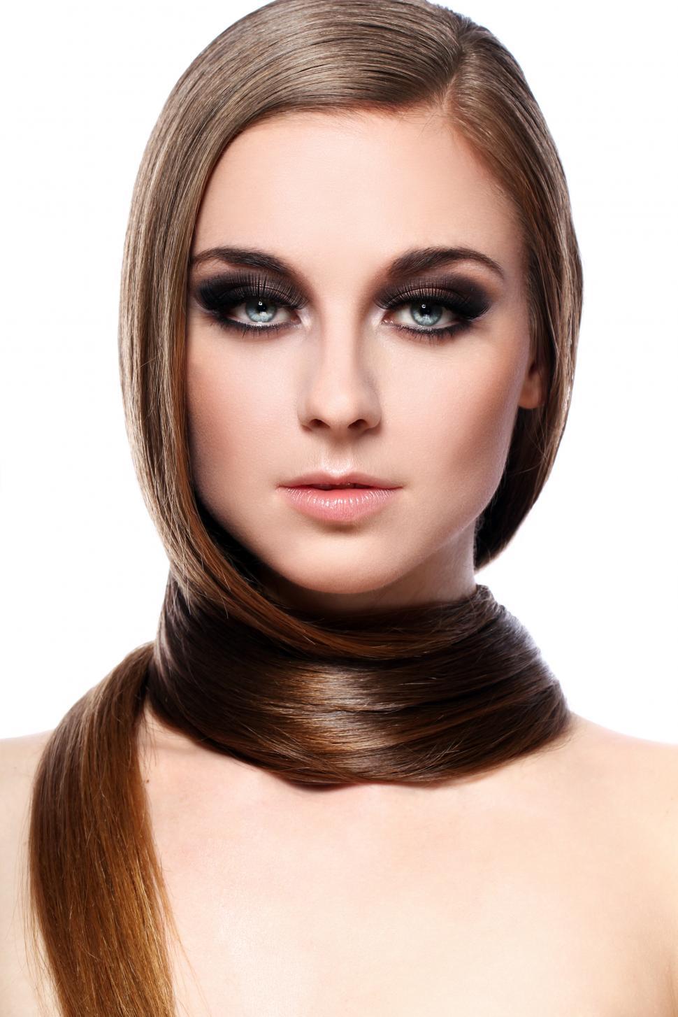 Free Image of Young woman wrapped in her long hair 