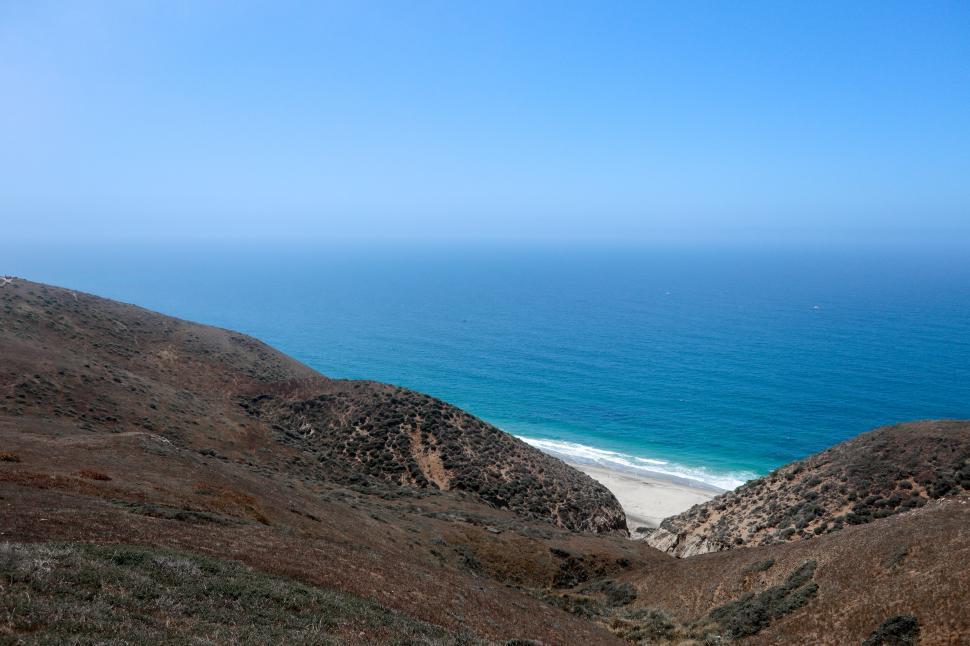 Free Image of Beach through Low Hills 