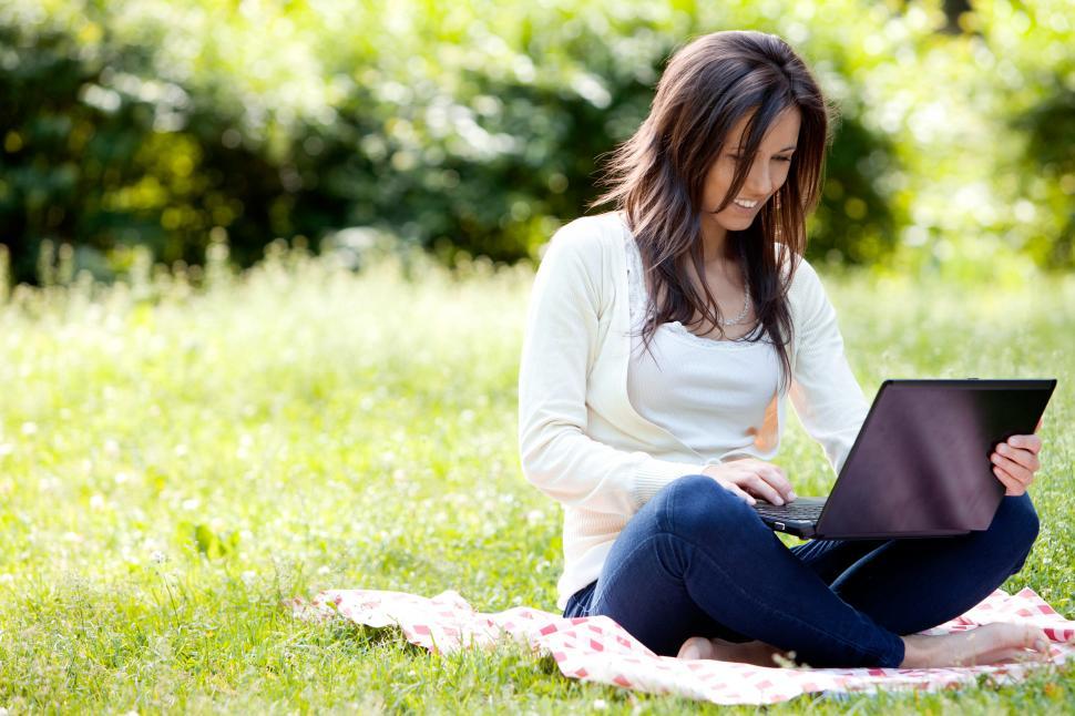 Free Image of Young girl with laptop working outdoors 