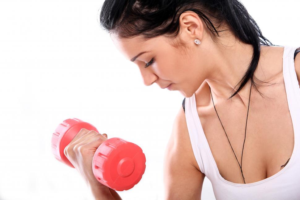 Free Image of Woman doing curls with red barbell 