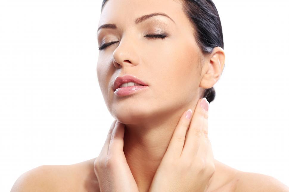 Free Image of Woman touching her neck with hands 