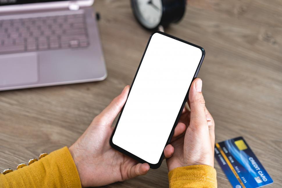 Free Image of Women hands holding Mobile Phone with blank screen and Credit Card 