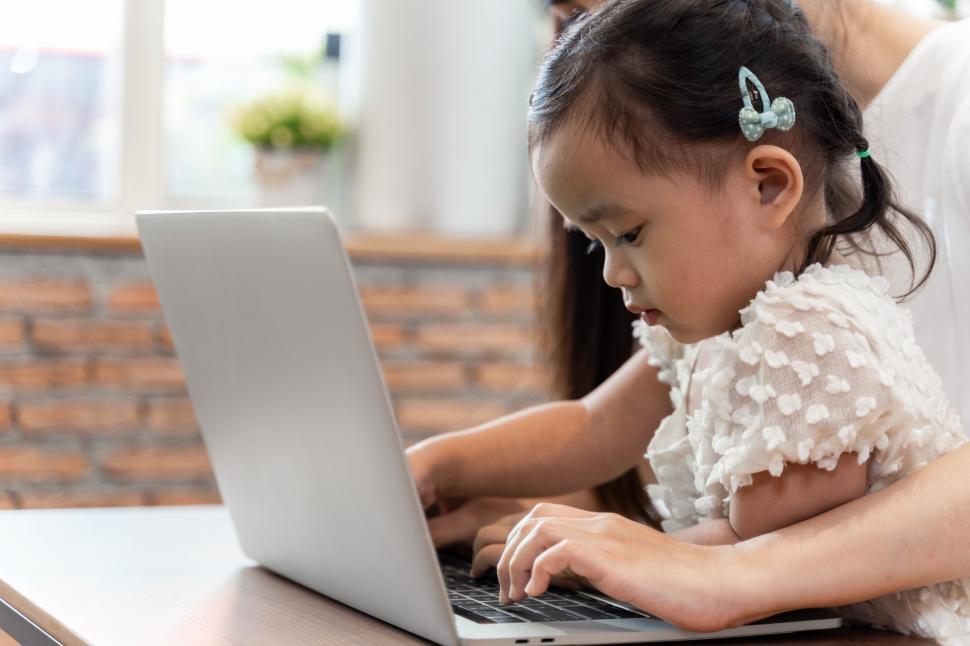 Free Image of Work from home concept. Mother and daughter using a computer 