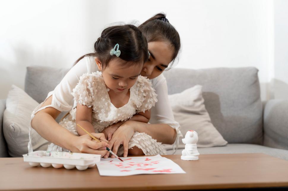 Free Image of Happy family. Mother and daughter together drawing 