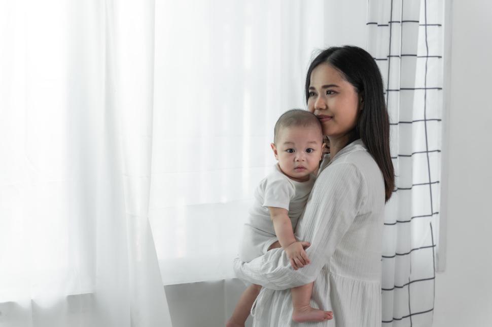 Free Image of Young beautiful asian mother with her cute newborn 