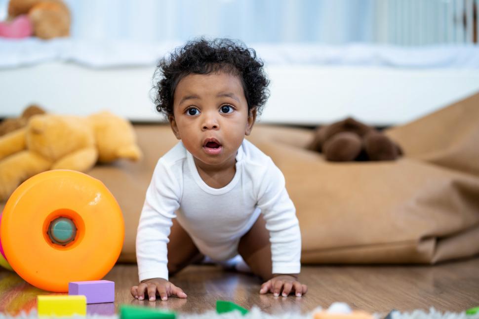 Free Image of Baby boy crawling on the floor 