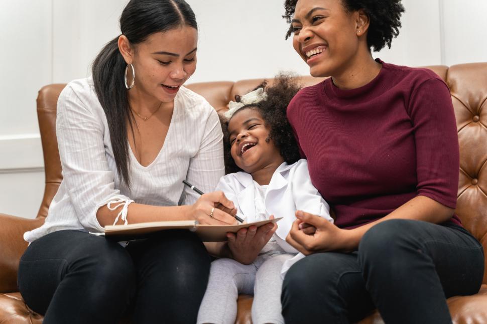 Free Image of Family Laughing Together on the Couch 