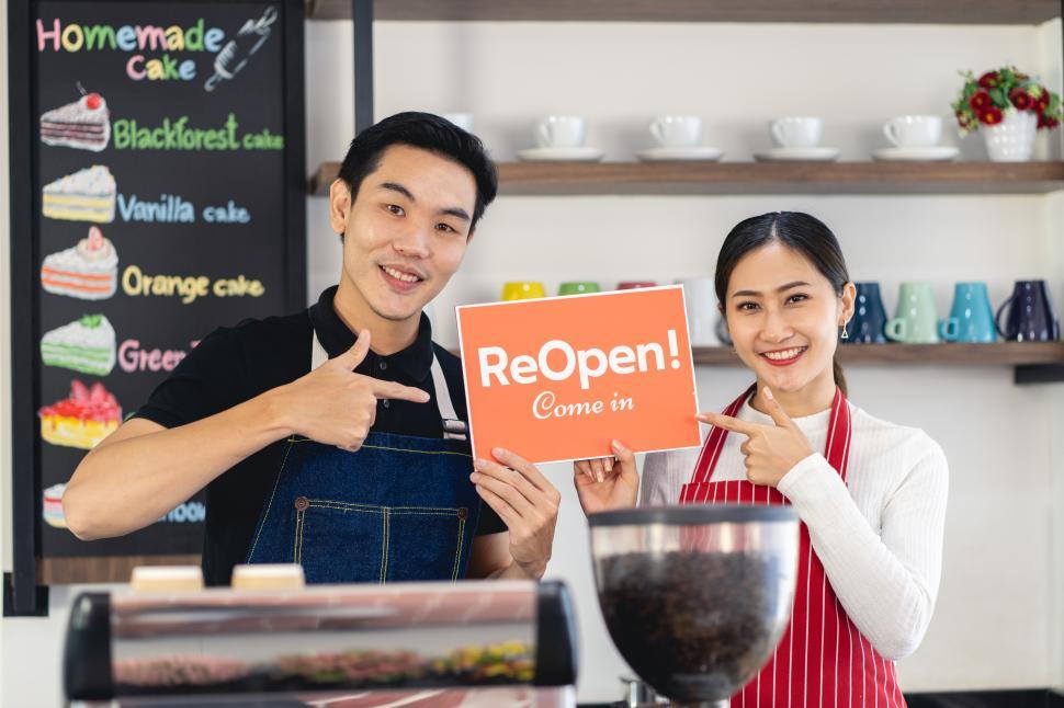 Free Image of Portrait of man and woman standing at her coffee shop 