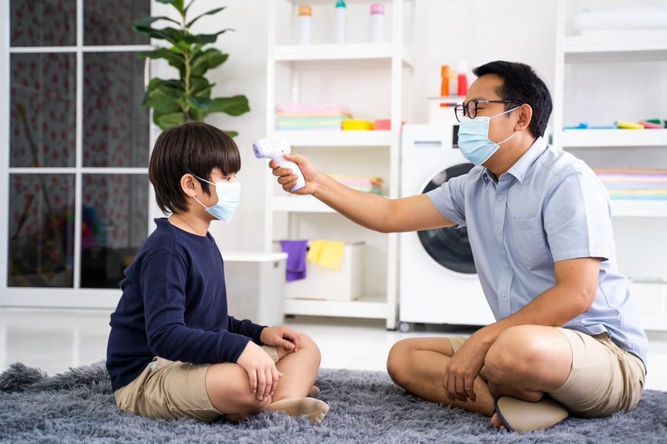 Free Image of Father takes childs temperature 