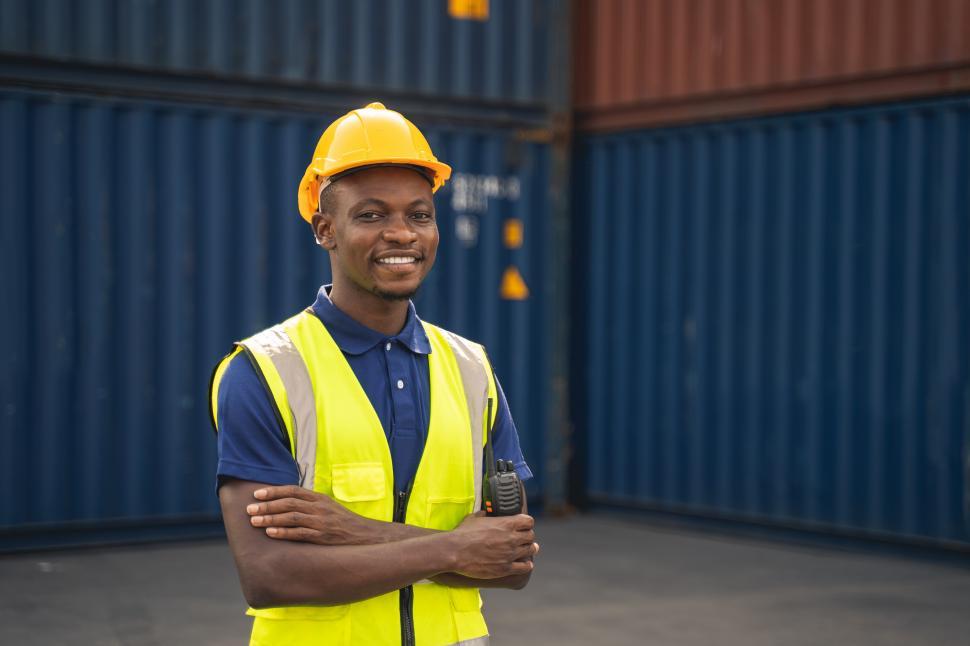 Free Image of Happy worker standing in the container workplace 