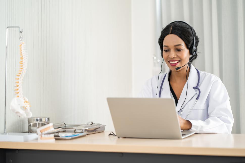 Free Image of Doctor in headset taking calls 