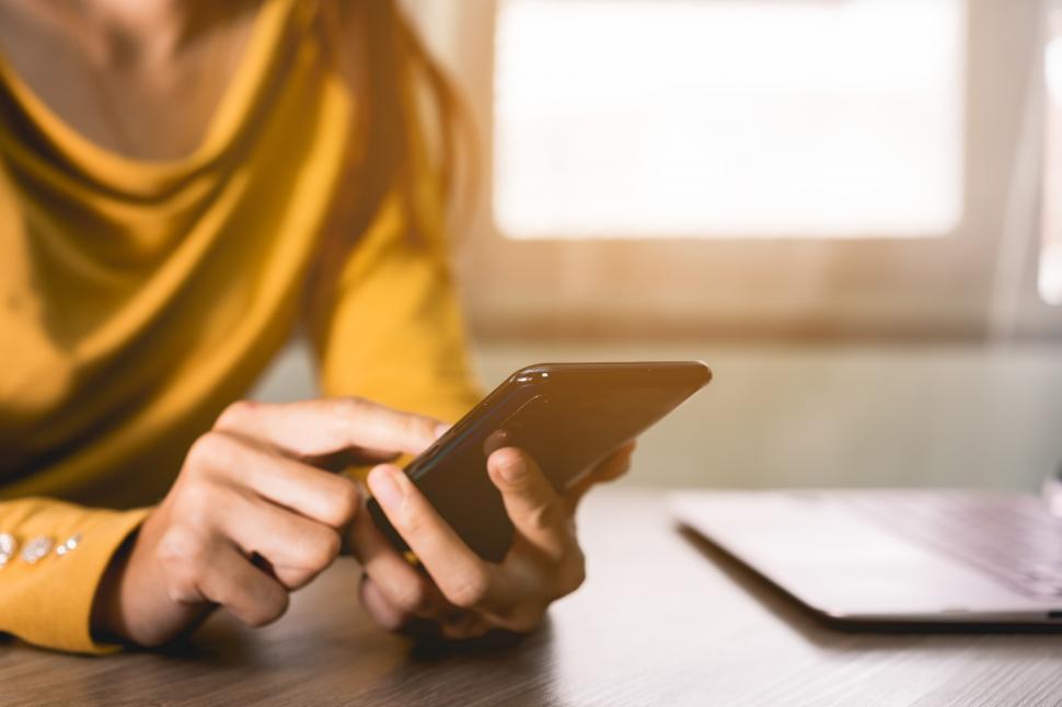 Free Image of Woman holding Mobile Phone 