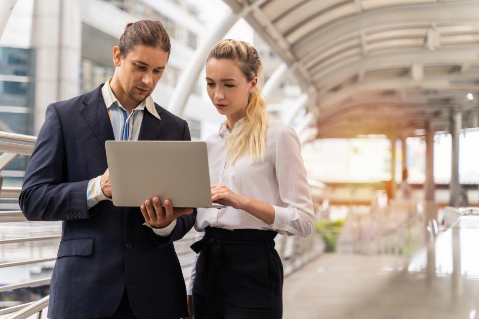 Free Image of Two business people working in a public space 