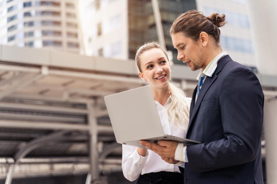 Free Image of Two business people discussing online data 
