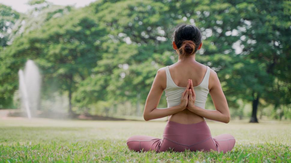 Free Image of Back view of an unrecognizable young woman doing yoga 