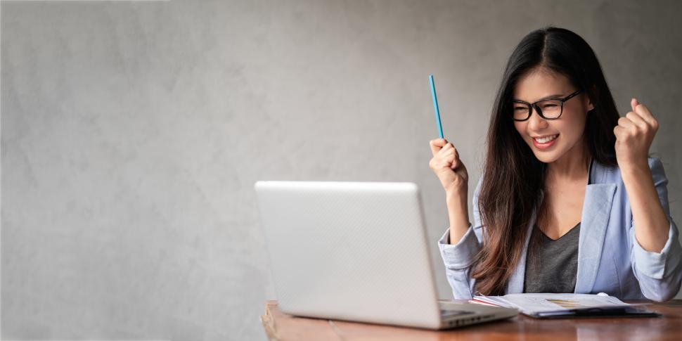 Free Image of Triumphant woman in blue shirt working from home 