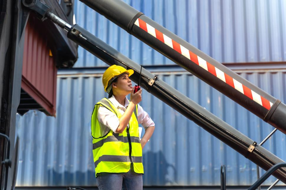 Free Image of Female worker directs cargo  