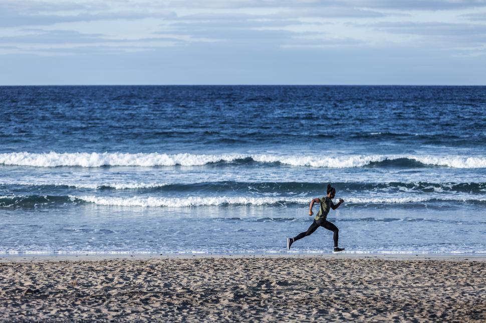 Free Image of Anonymous black sportsman running near sea 