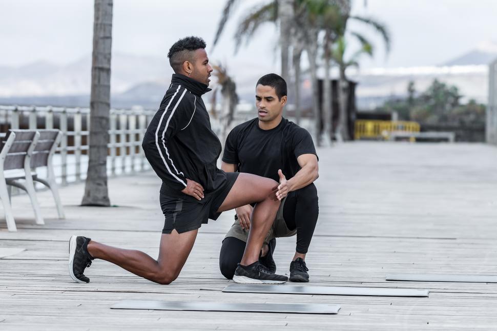Free Image of Instructor helping athlete to perform lunges 