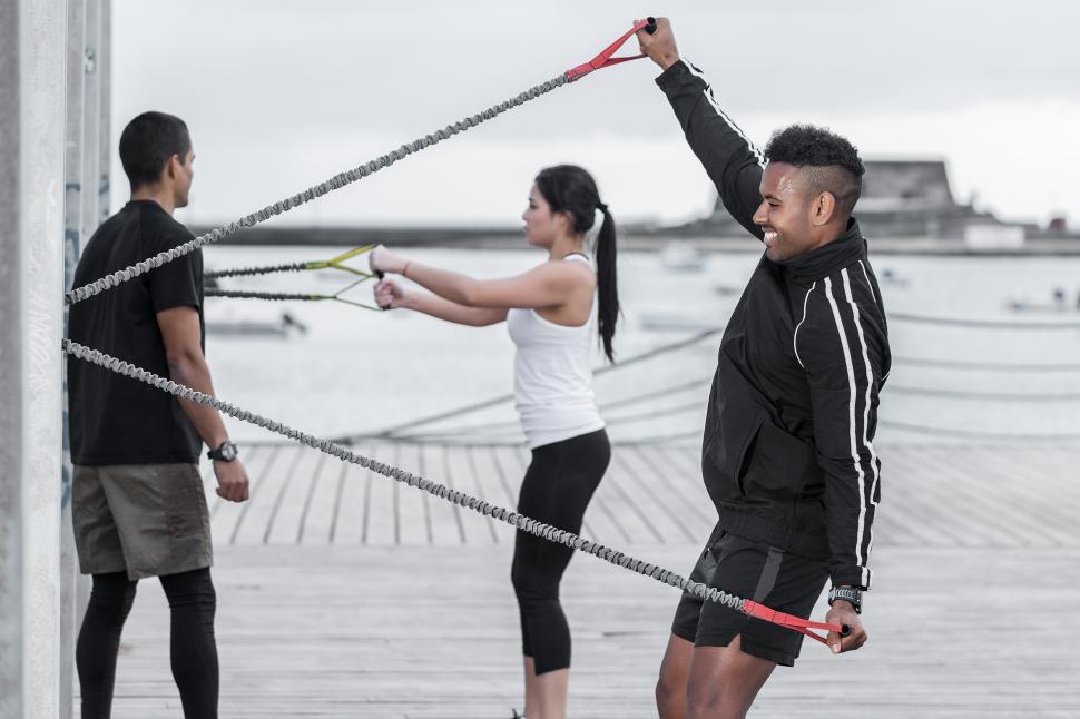 Free Image of Cheerful black man exercising with resistance band 