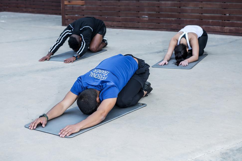 Free Image of Trainer an athletes in Child Pose 