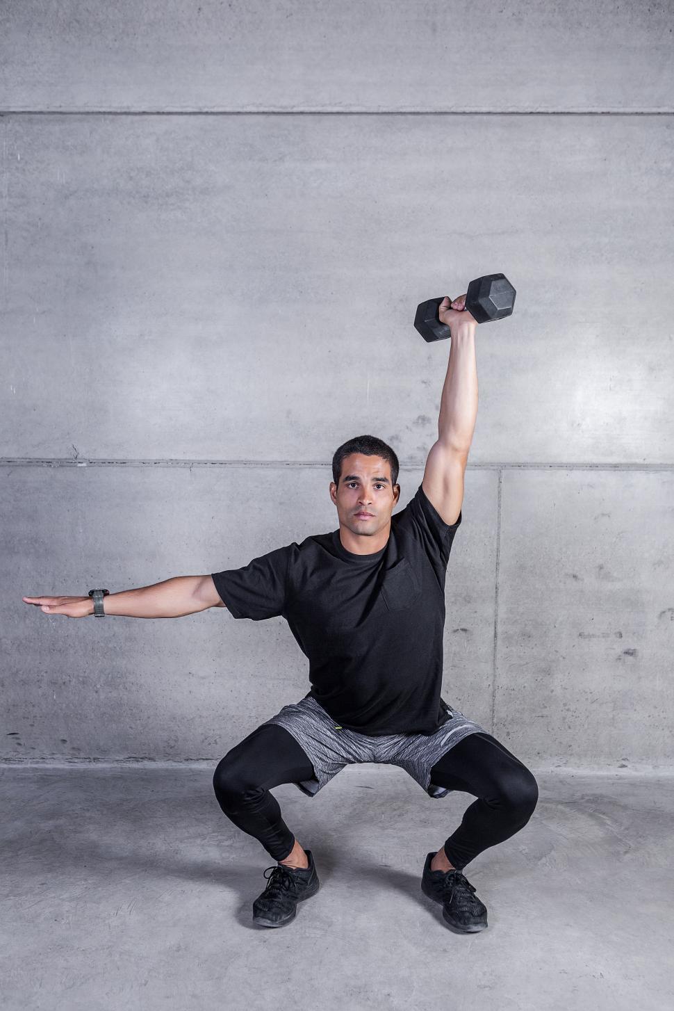 Free Image of Athletic man doing dumbbell exercise 