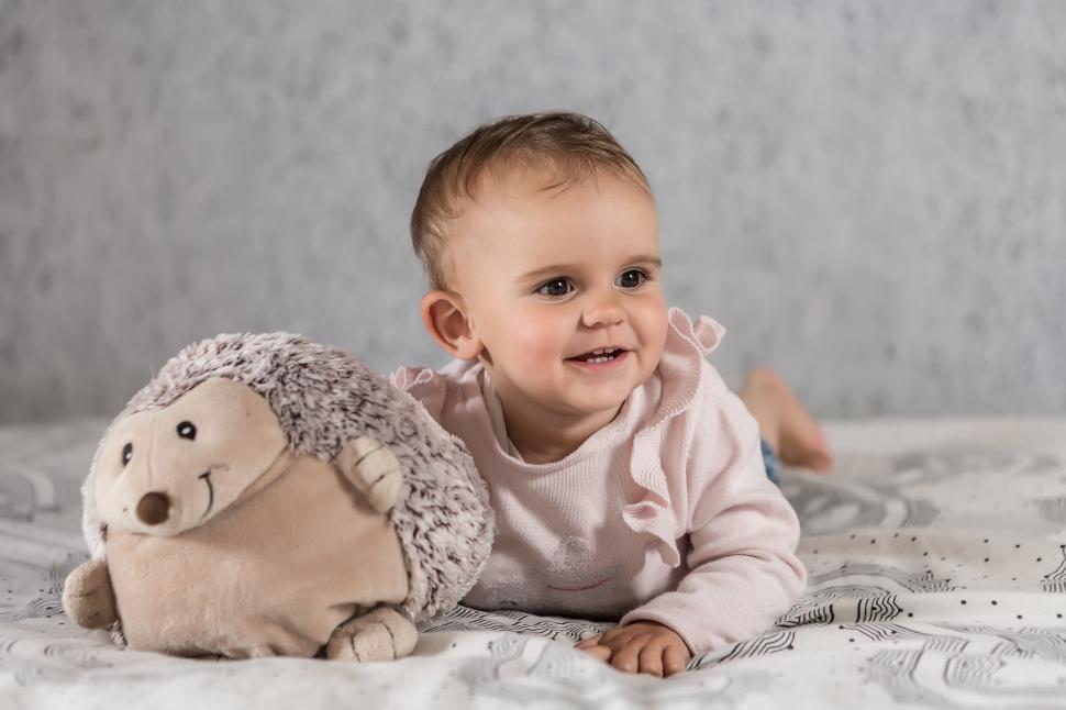 Free Image of Baby on bed with toy 
