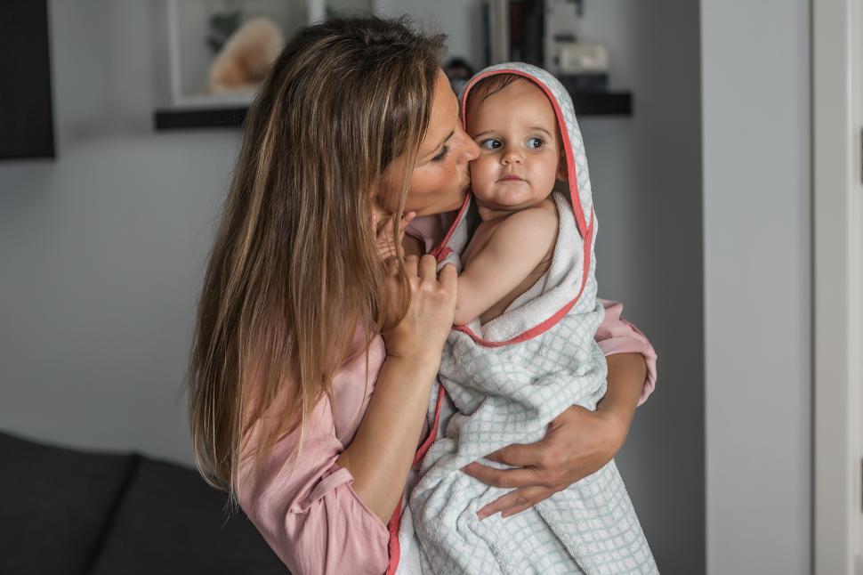Free Image of Mother kissing her baby after bath 